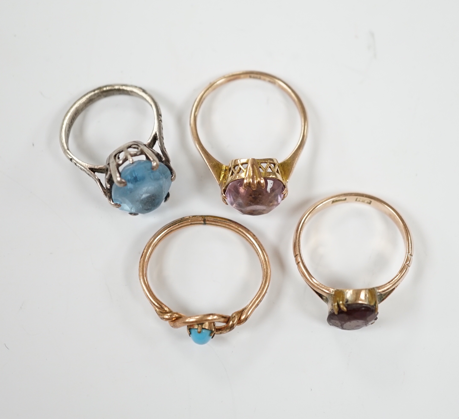 Two yellow metal and gem set rings, one stamped 9ct, gross weight 7.7 grams and two other rings.